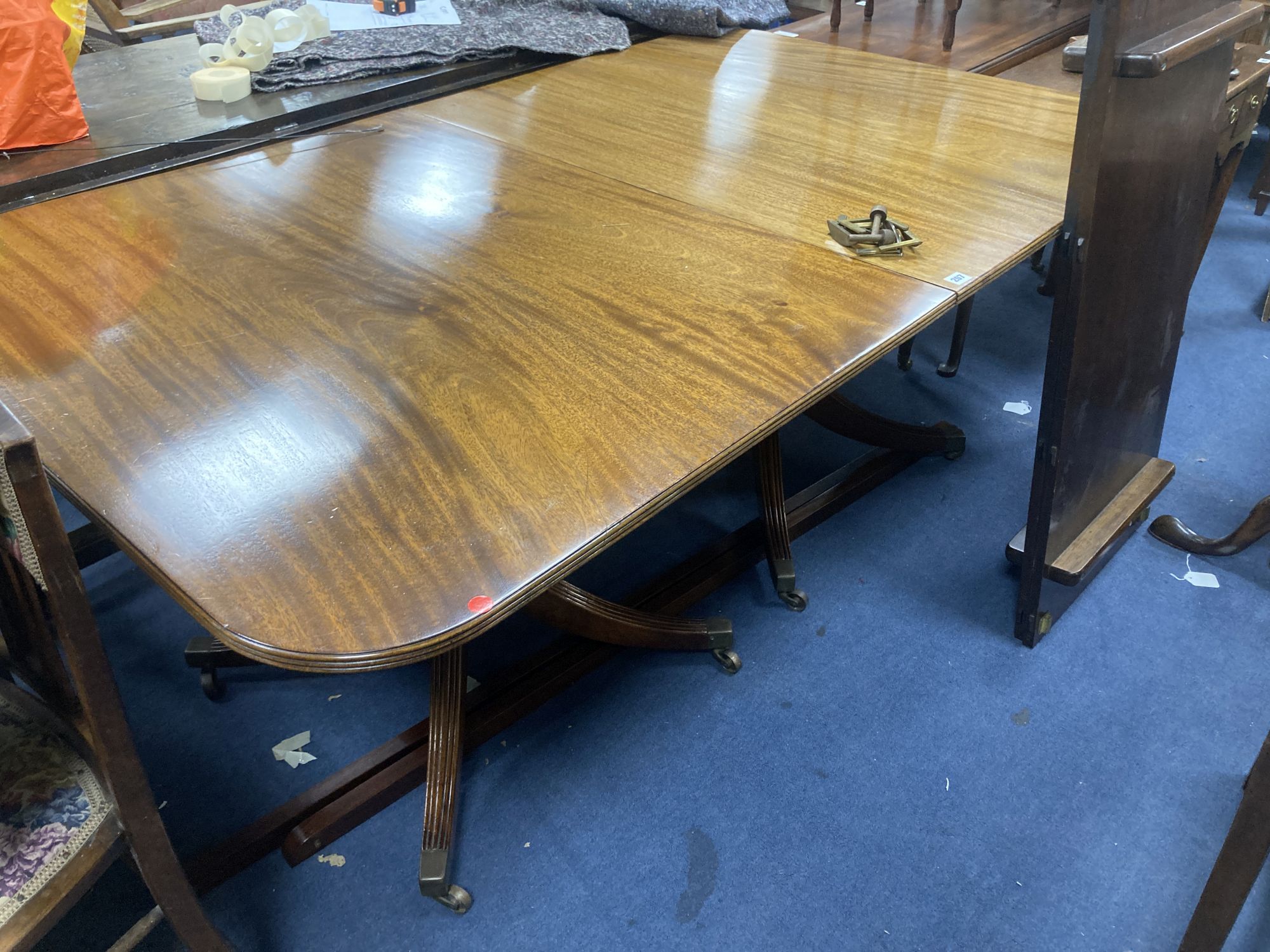 A George III style mahogany twin pedestal dining table, with two spare leaves, length 175cm, depth 106cm, height 71cm